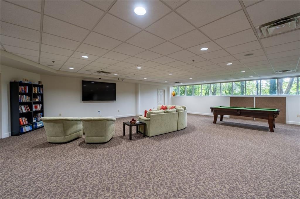3101 Howell Mill Road Northwest, Unit 227 Atlanta, GA 30327 - Photo 48 of 48 a living room with furniture and a flat screen tv