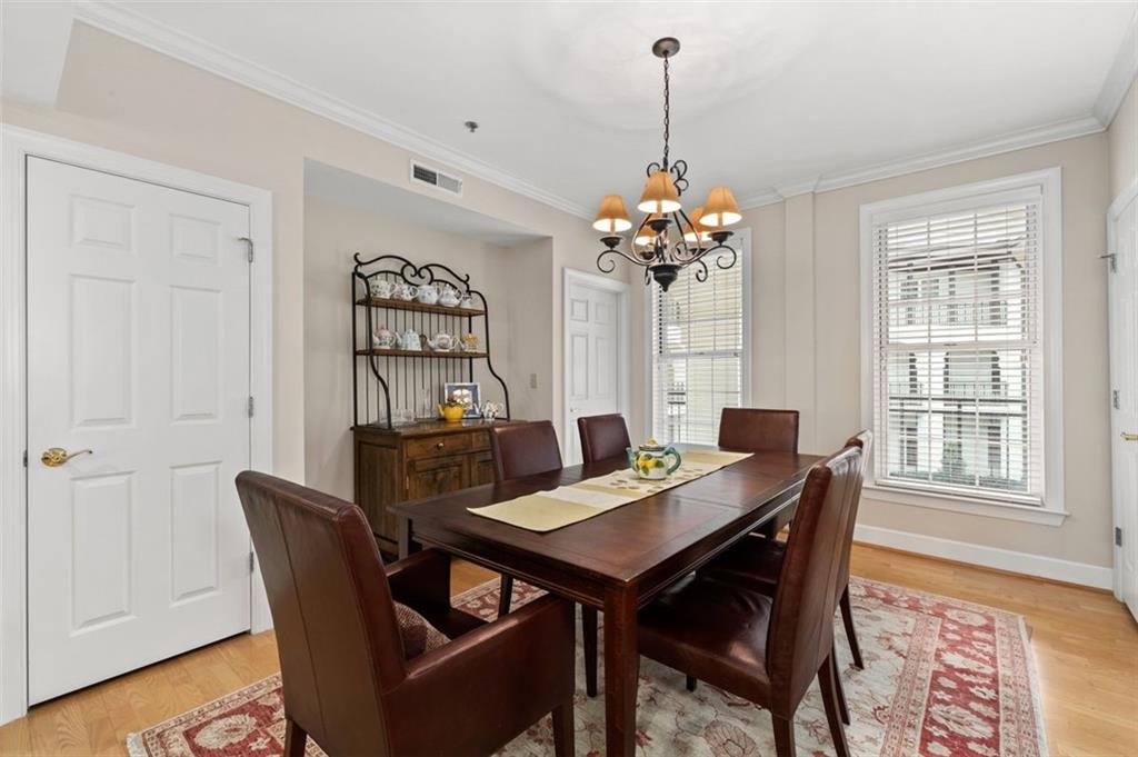 3101 Howell Mill Road Northwest, Unit 227 Atlanta, GA 30327 - Photo 8 of 48 a view of a dining room with furniture window and wooden floor