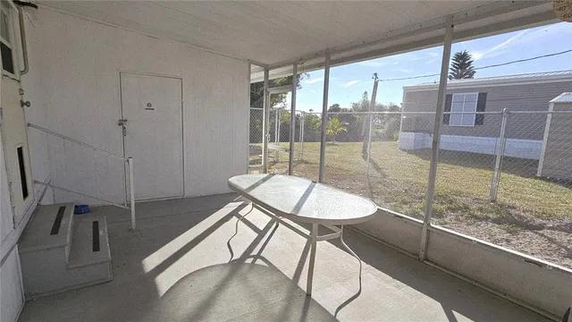 a dining room with furniture and a floor to ceiling window