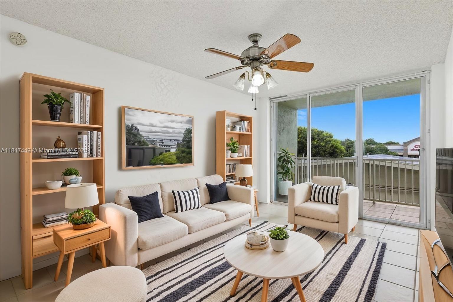 616 Northwest 26th Avenue, Unit 210 Miami, FL 33125 - Photo 1 of 23 a living room with furniture and a floor to ceiling window