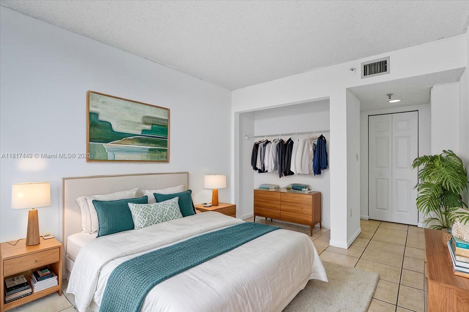 616 Northwest 26th Avenue, Unit 210 Miami, FL 33125 - Photo 12 of 23 a bedroom with bed and walk in closet