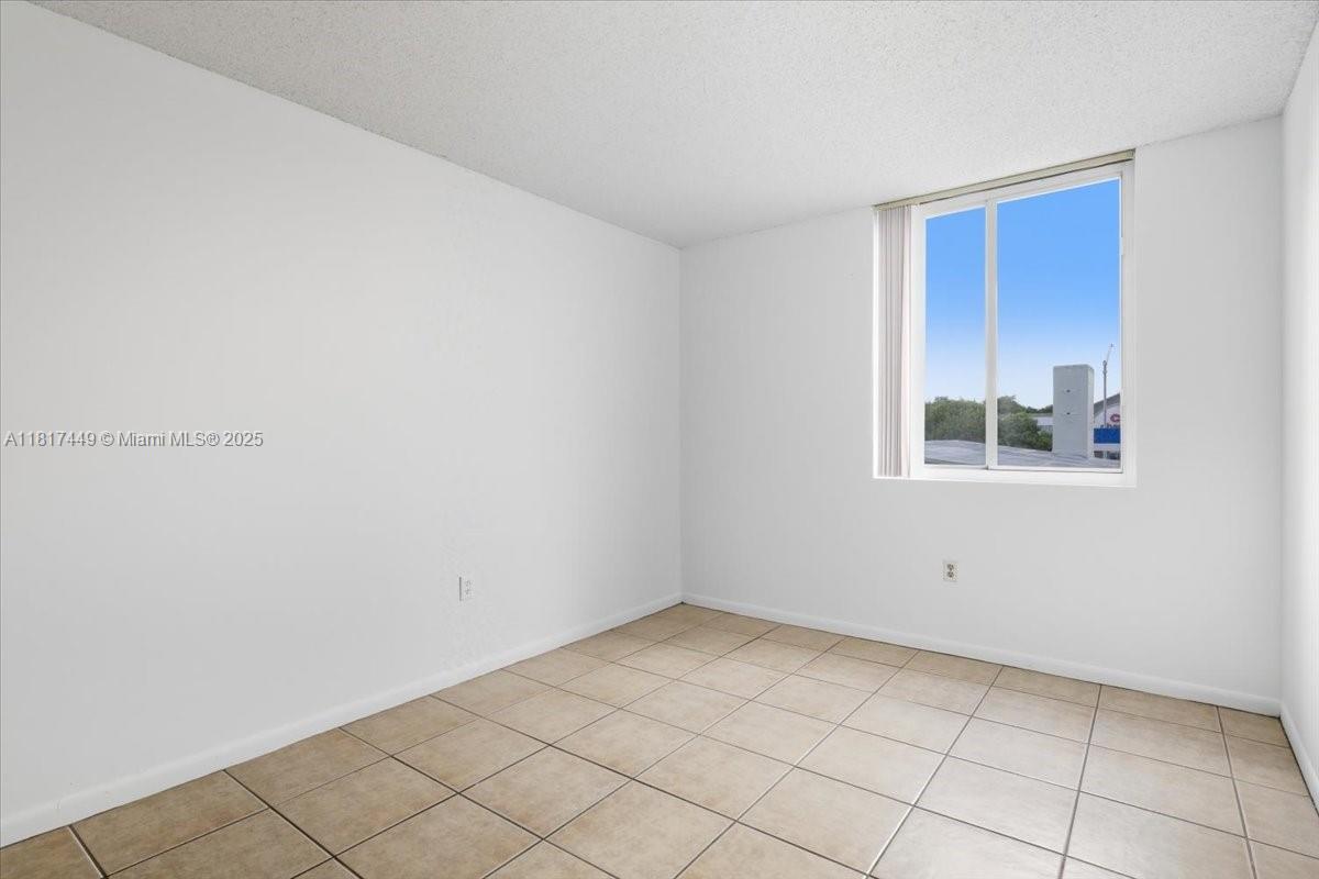 616 Northwest 26th Avenue, Unit 210 Miami, FL 33125 - Photo 14 of 23 a view of an empty room with a window