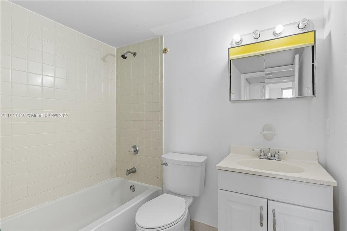 616 Northwest 26th Avenue, Unit 210 Miami, FL 33125 - Photo 16 of 23 a bathroom with a sink toilet and vanity