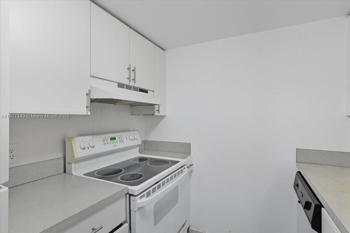 616 Northwest 26th Avenue, Unit 210 Miami, FL 33125 - Photo 17 of 23 a kitchen with a stove and a microwave