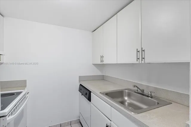 a kitchen with a sink and cabinets