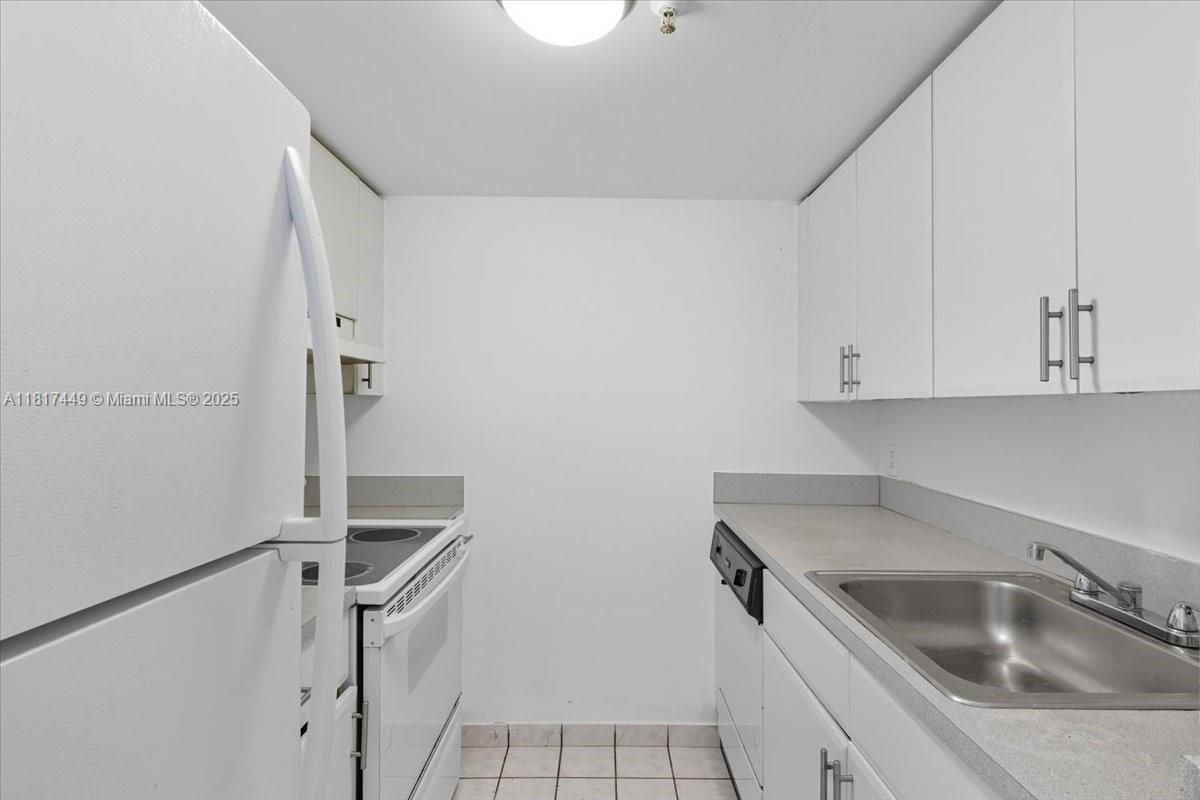 616 Northwest 26th Avenue, Unit 210 Miami, FL 33125 - Photo 19 of 23 a kitchen with a sink and cabinets
