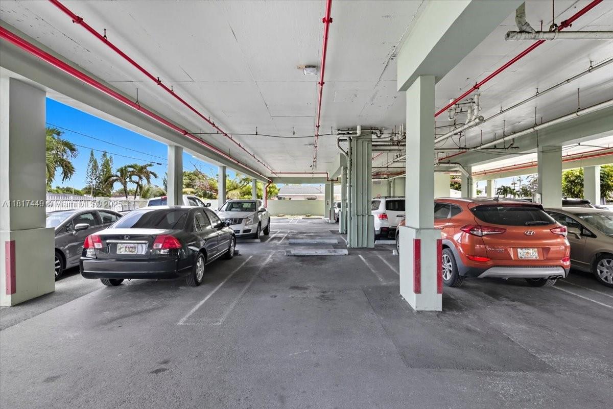 616 Northwest 26th Avenue, Unit 210 Miami, FL 33125 - Photo 22 of 23 a view of cars parked in a parking