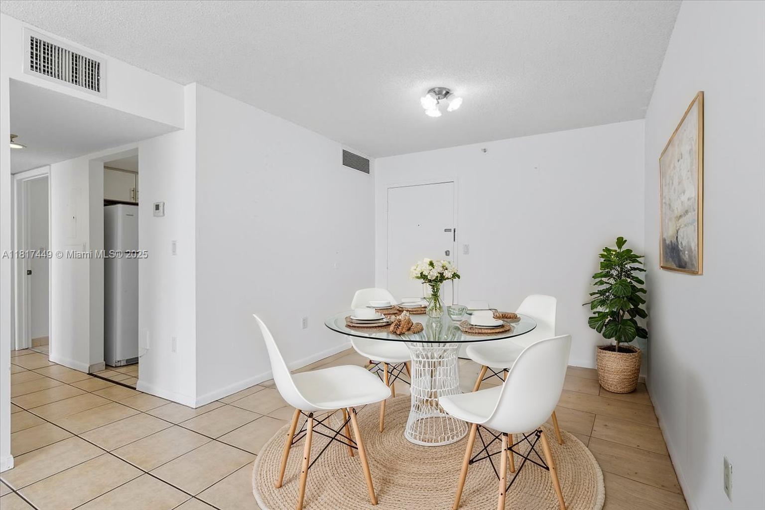 616 Northwest 26th Avenue, Unit 210 Miami, FL 33125 - Photo 5 of 23 a view of a dining room with furniture and wooden floor