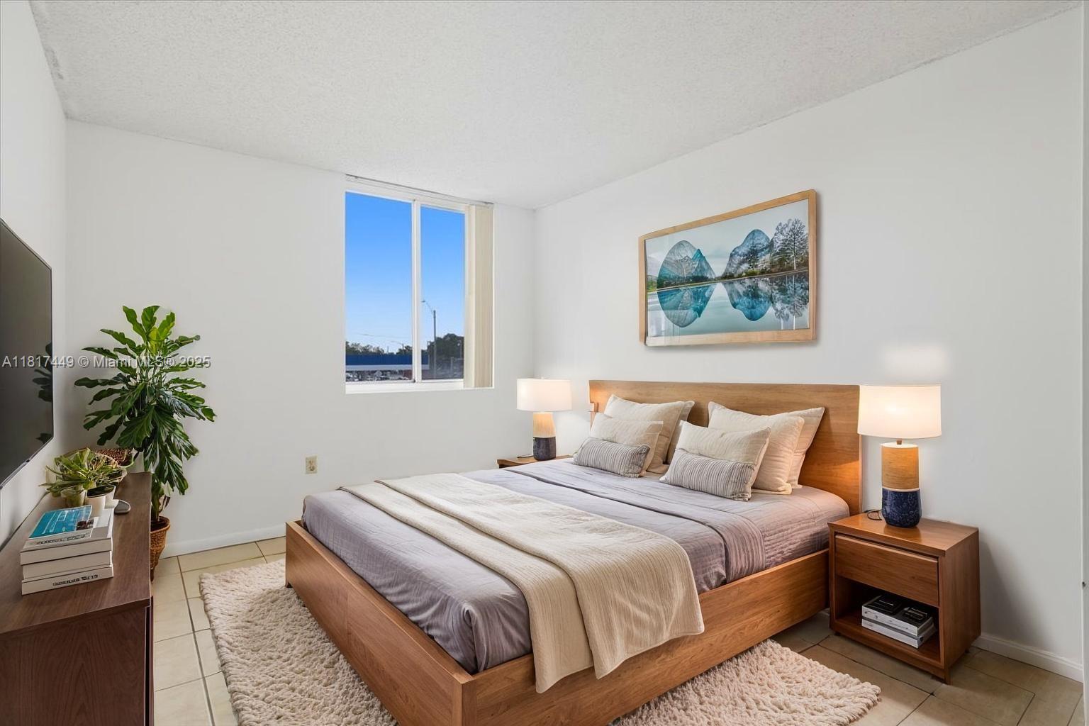 616 Northwest 26th Avenue, Unit 210 Miami, FL 33125 - Photo 10 of 23 a bedroom with a bed and a potted plant