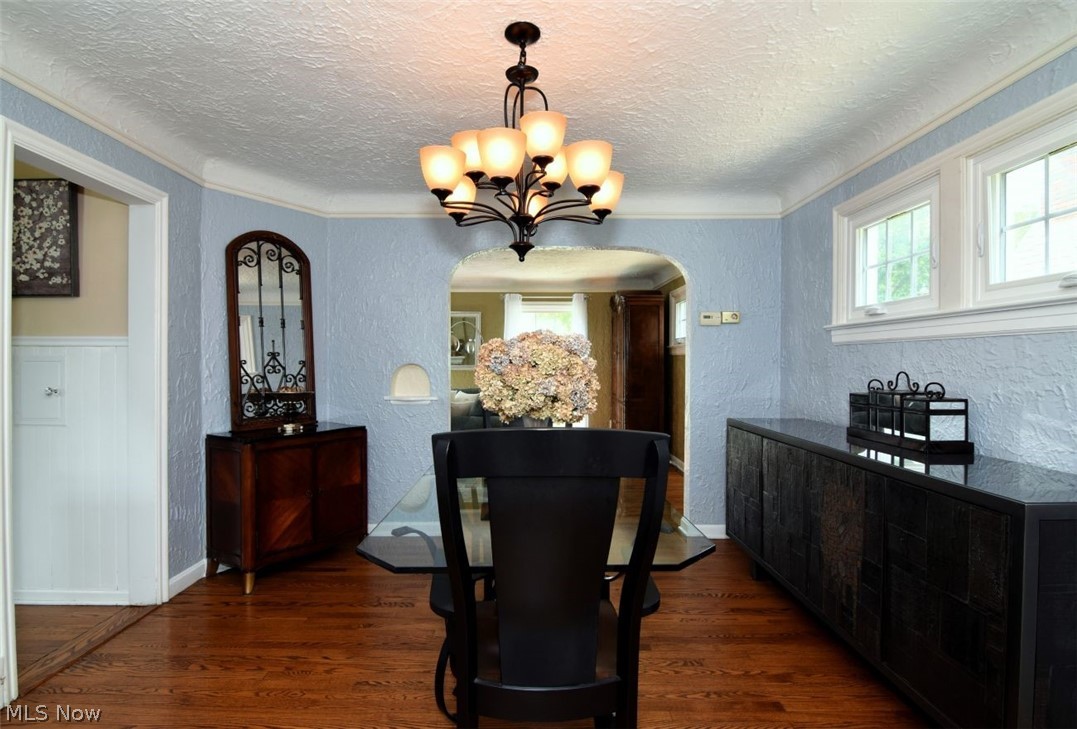 3451 Edison Road Cleveland Heights, OH 44121 - Photo 13 of 46 Hardwood flooring, arched doorway, two windows with white trim, white crown molding, and a multi-light chandelier