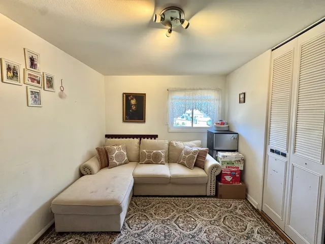 a bedroom with furniture and a window