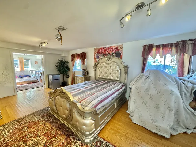 a bedroom with a bed and window