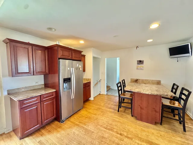 a kitchen with stainless steel appliances a refrigerator and wooden cabinets