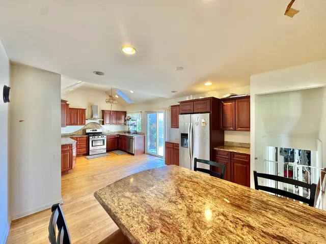 a view of a kitchen with kitchen island dining table and wooden floor