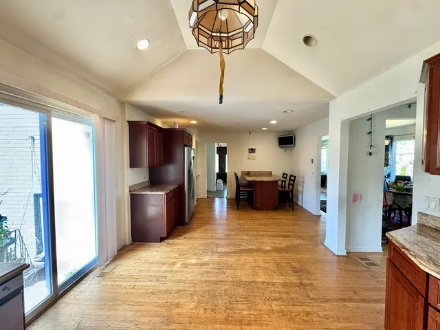 a view of a kitchen with furniture and a refrigerator