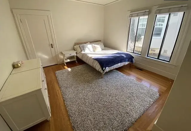 a bed sitting in a room next to a window