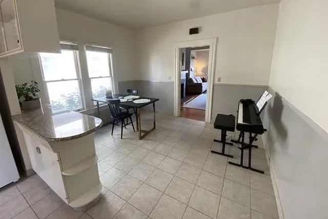 a dining room filled with furniture and window