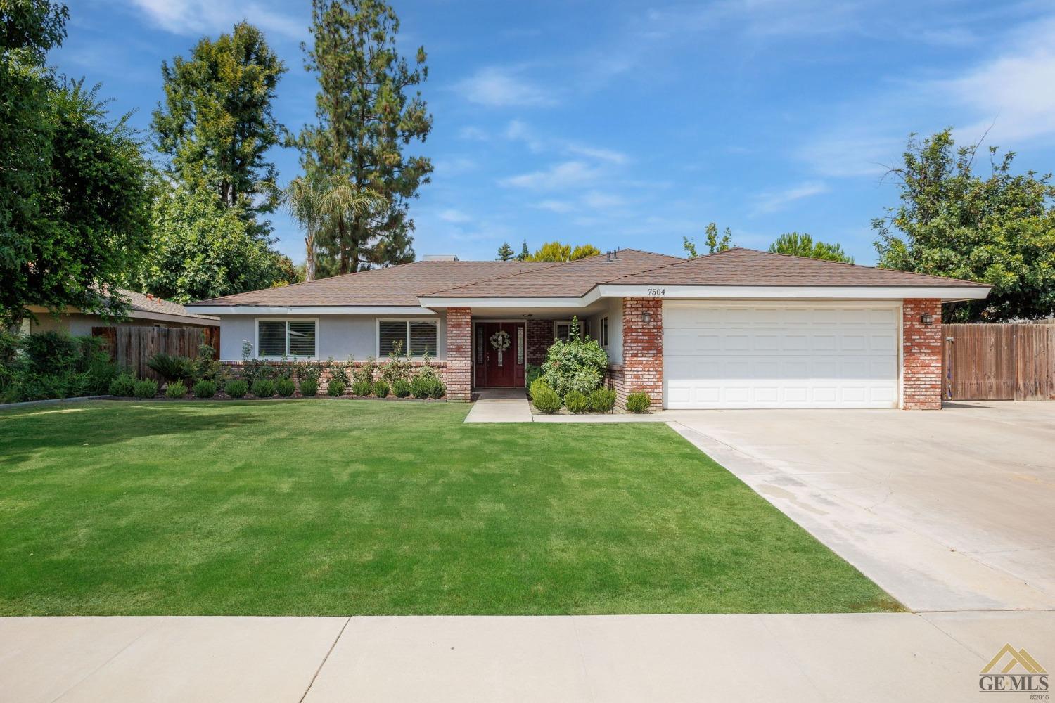 a black and white house with a garden