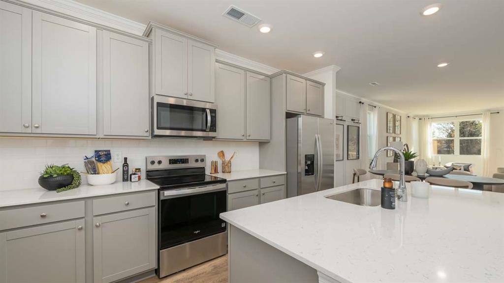 717 Alburgh Alley Mableton, GA 30126 - Photo 18 of 38 a kitchen with a sink a stove and refrigerator