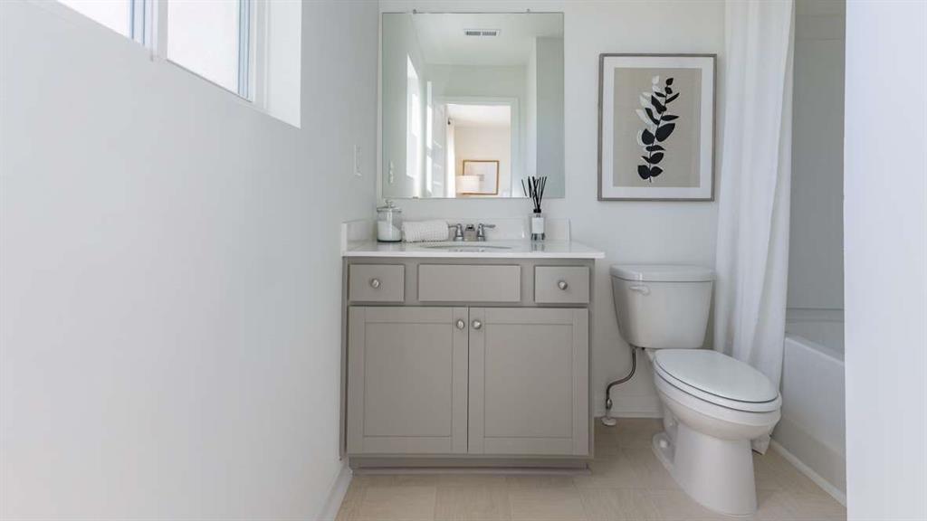 717 Alburgh Alley Mableton, GA 30126 - Photo 28 of 38 a bathroom with a toilet sink vanity and mirror
