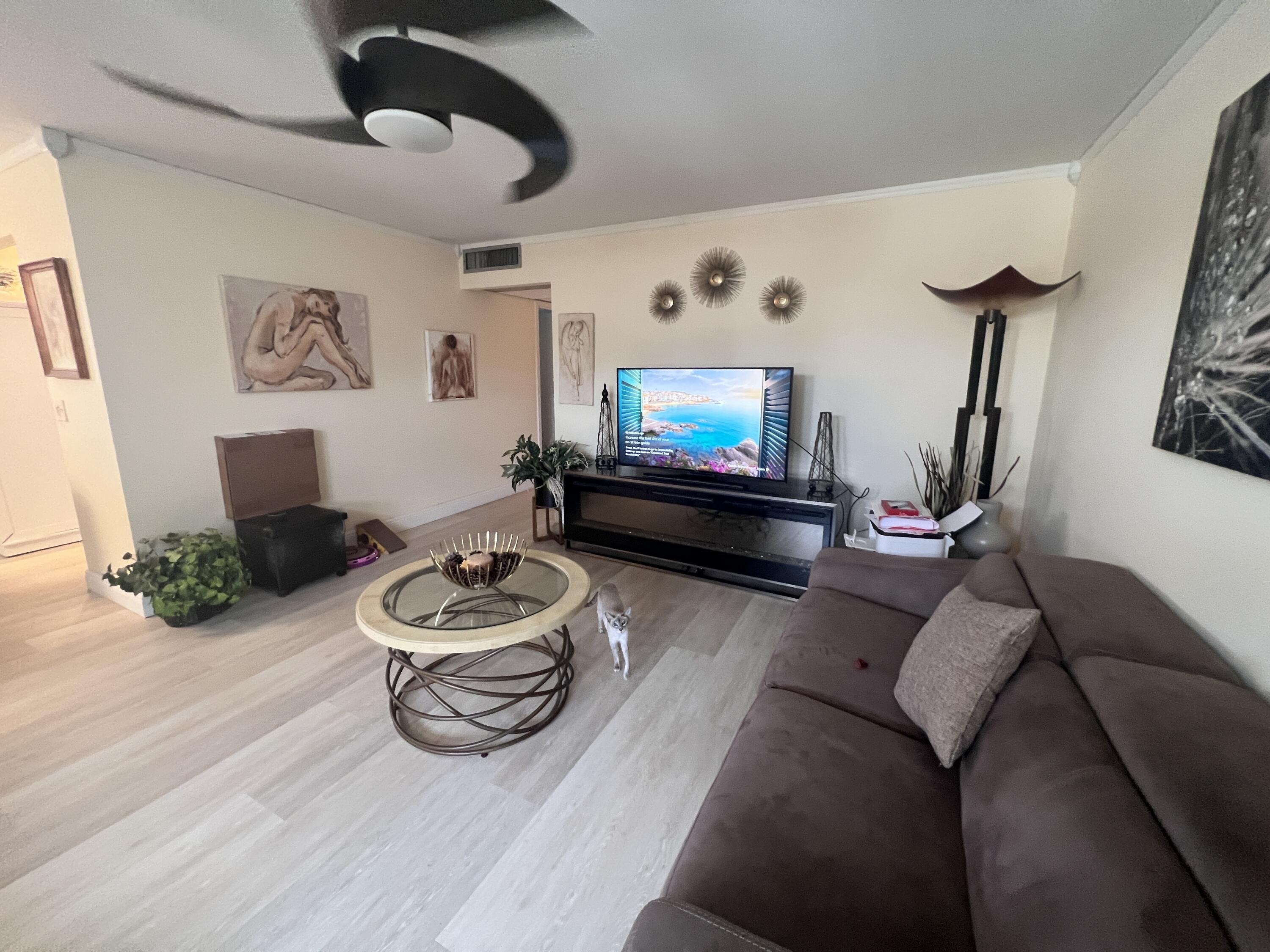 652 Flanders North Delray Beach, FL 33484 - Photo 11 of 27 a living room with furniture and a flat screen tv