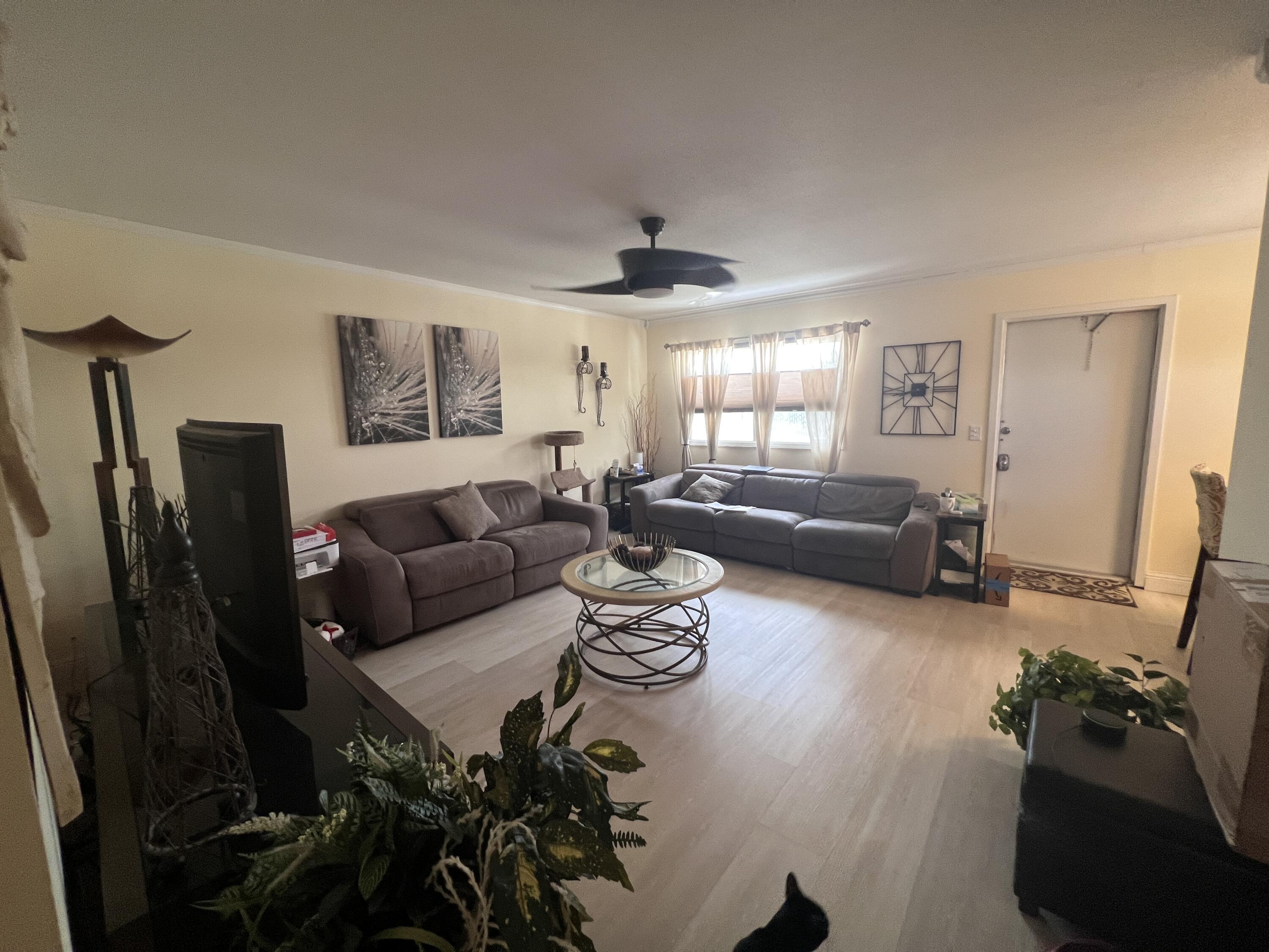 652 Flanders North Delray Beach, FL 33484 - Photo 14 of 27 a living room with furniture rug and a window