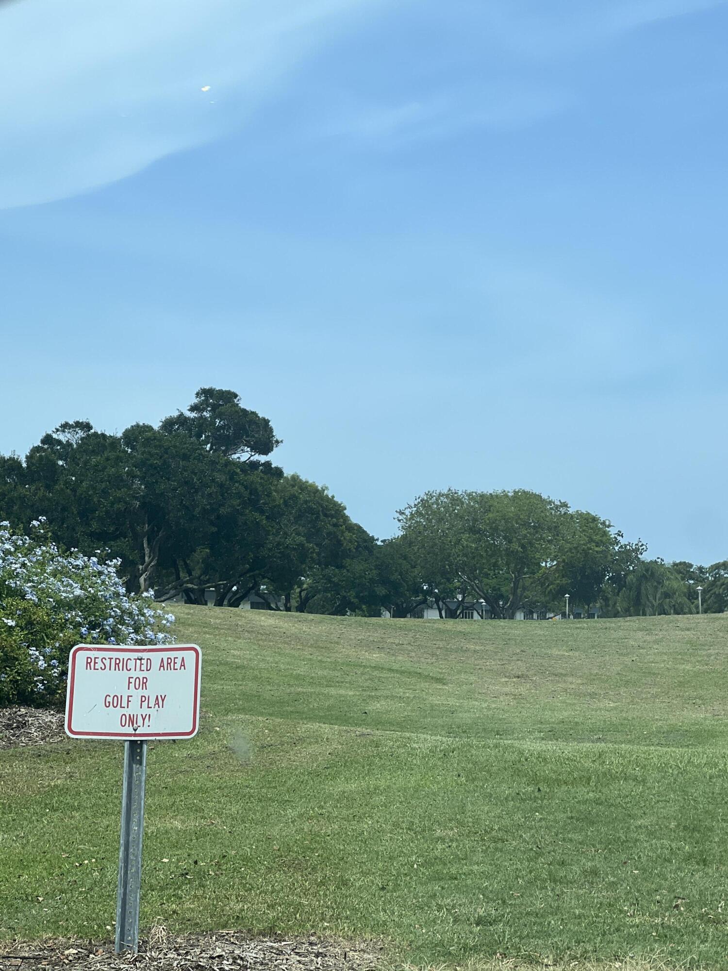 652 Flanders North Delray Beach, FL 33484 - Photo 3 of 27 a view of a park with a bench and trees