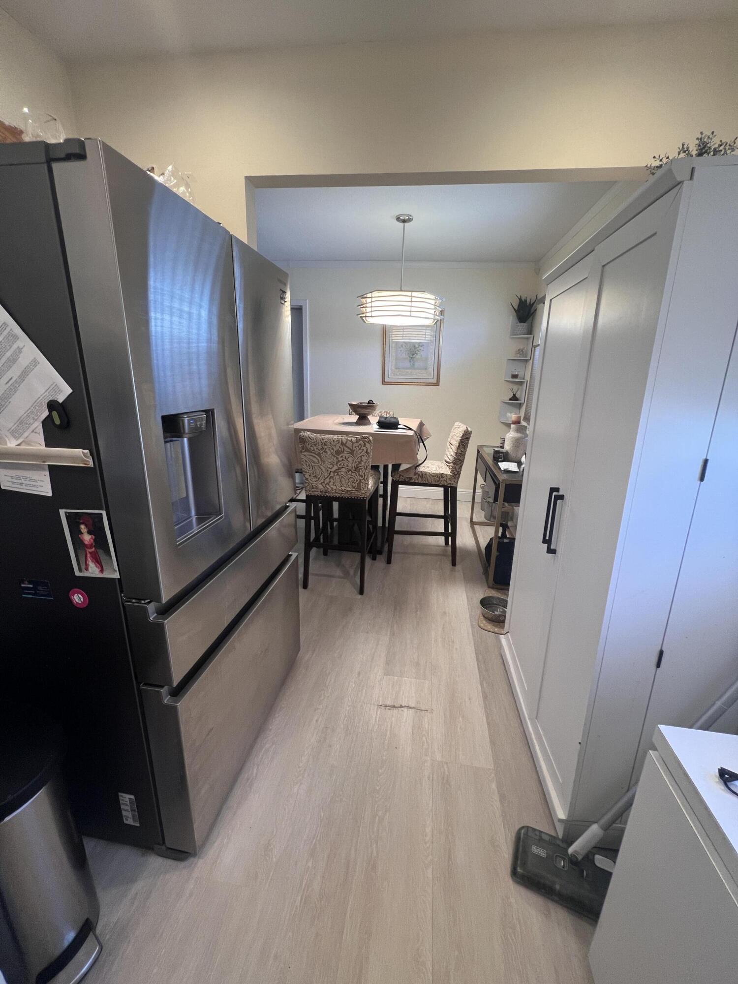 652 Flanders North Delray Beach, FL 33484 - Photo 7 of 27 a dining room with furniture and wooden floor