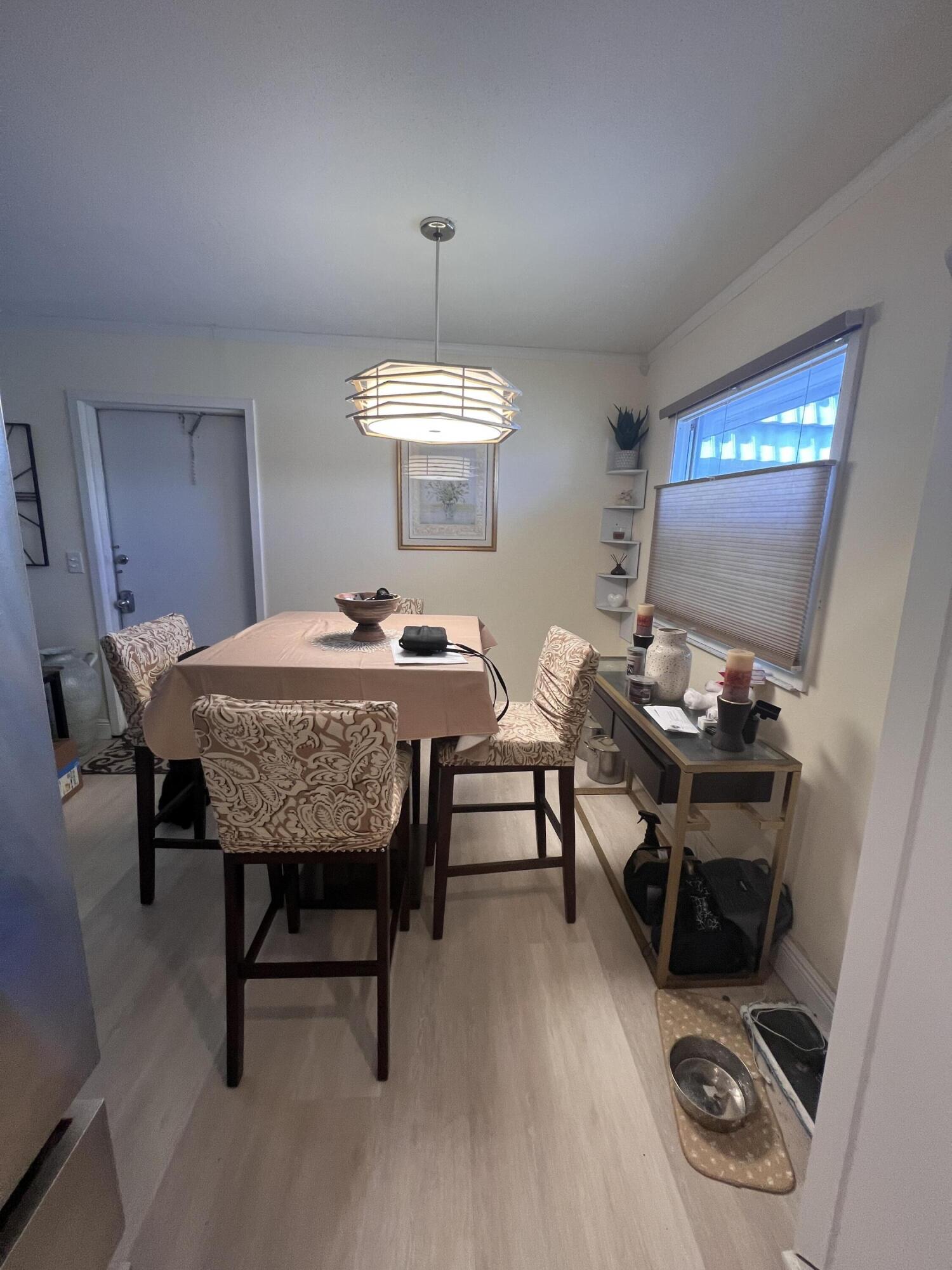 652 Flanders North Delray Beach, FL 33484 - Photo 8 of 27 a view of a dining room with furniture and wooden floor