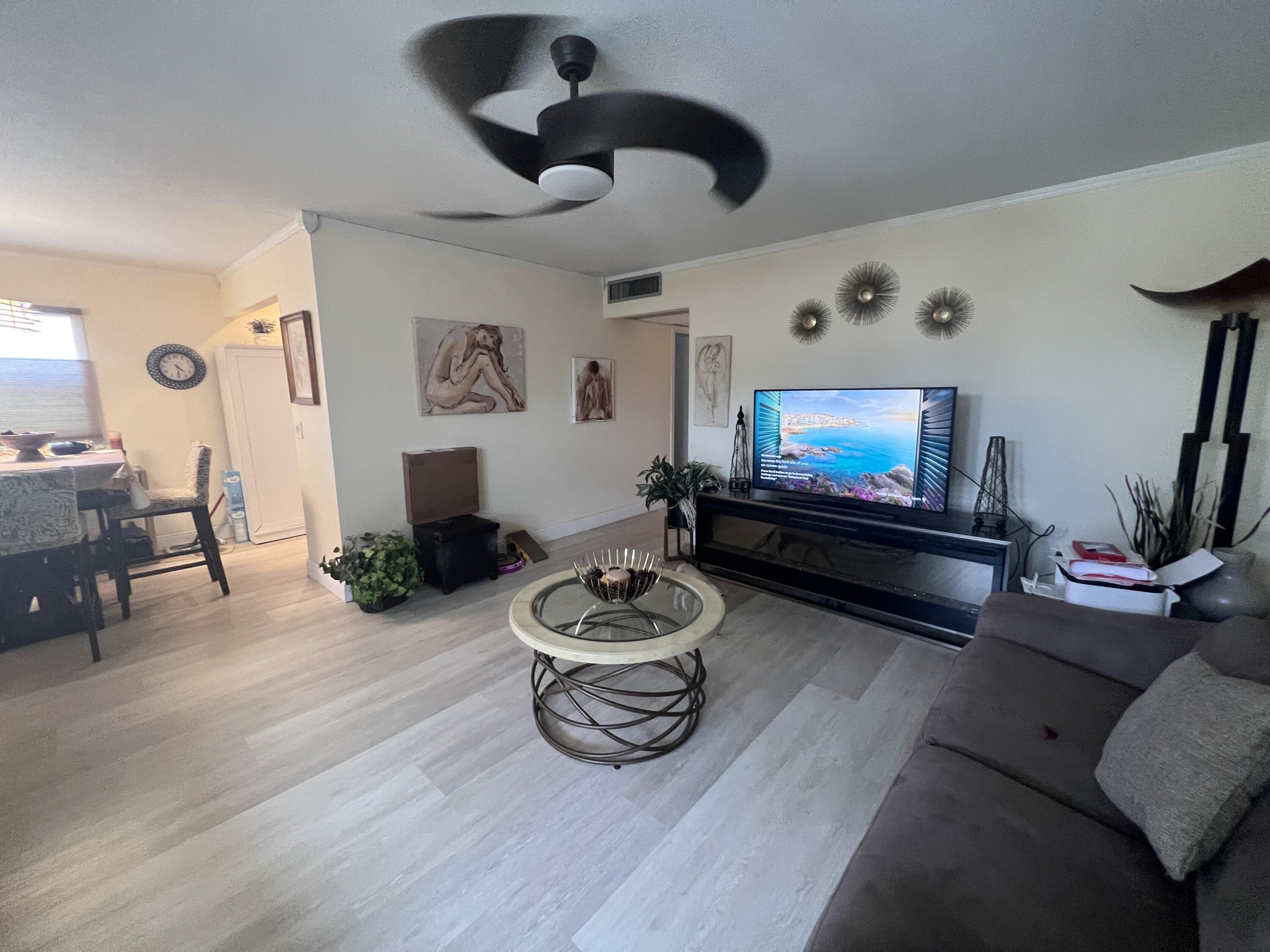652 Flanders North Delray Beach, FL 33484 - Photo 10 of 27 a living room with furniture and a flat screen tv