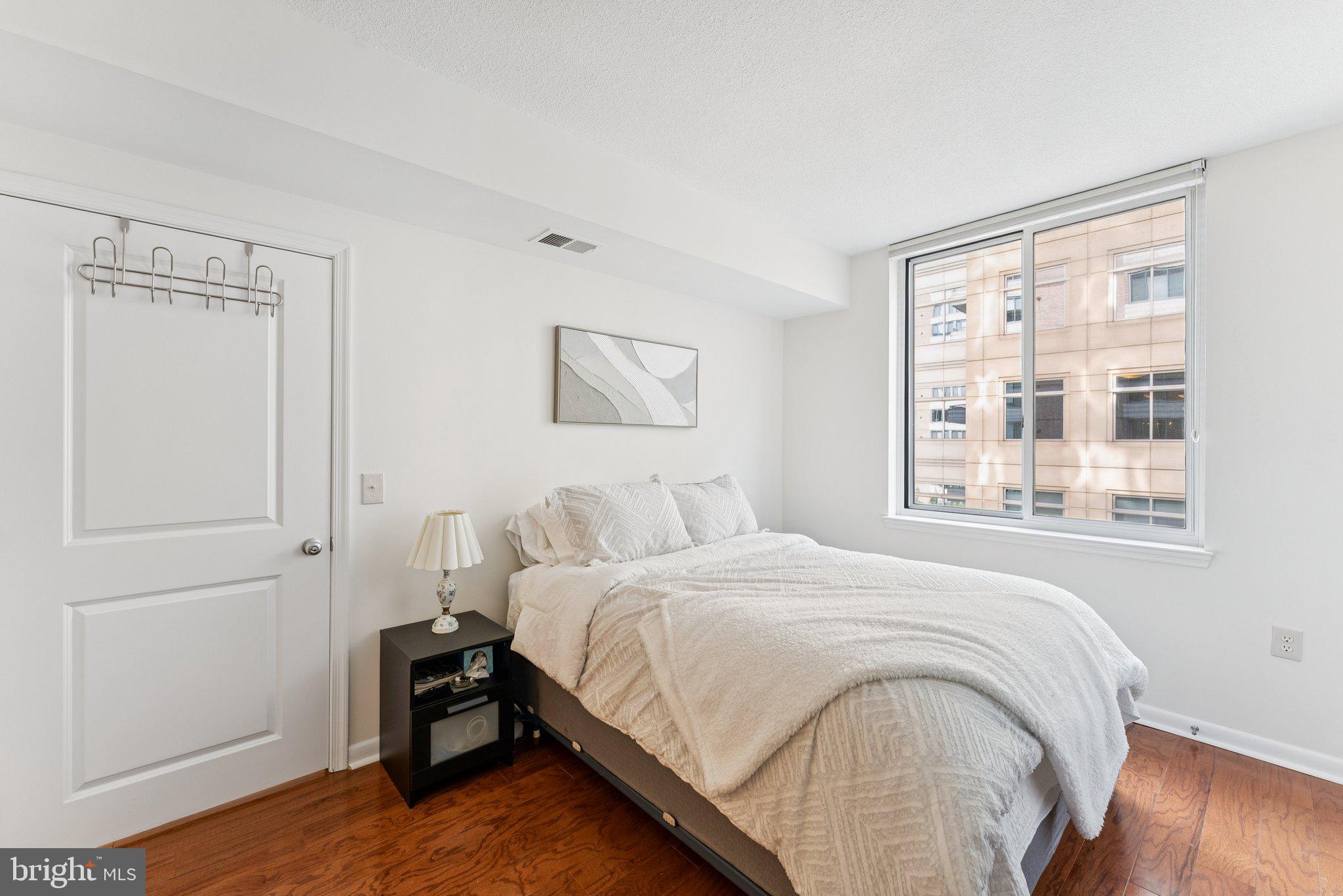 851 North Glebe Road, Unit 718 Arlington, VA 22203 - Photo 13 of 37 a bedroom with a bed and a window