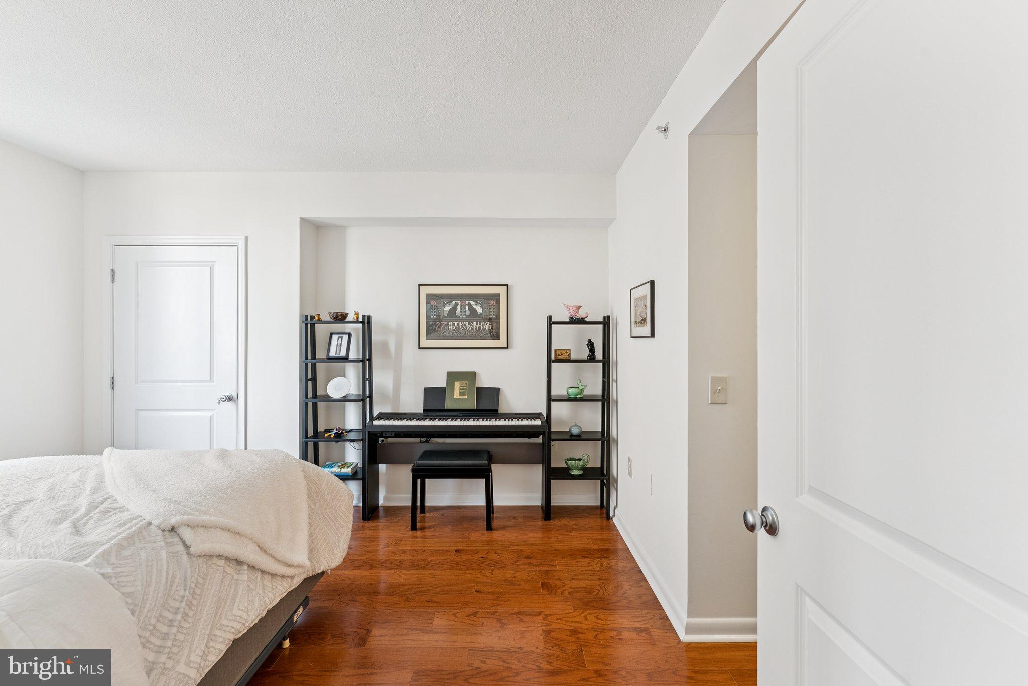 851 North Glebe Road, Unit 718 Arlington, VA 22203 - Photo 15 of 37 a bedroom with a bed and a table in it