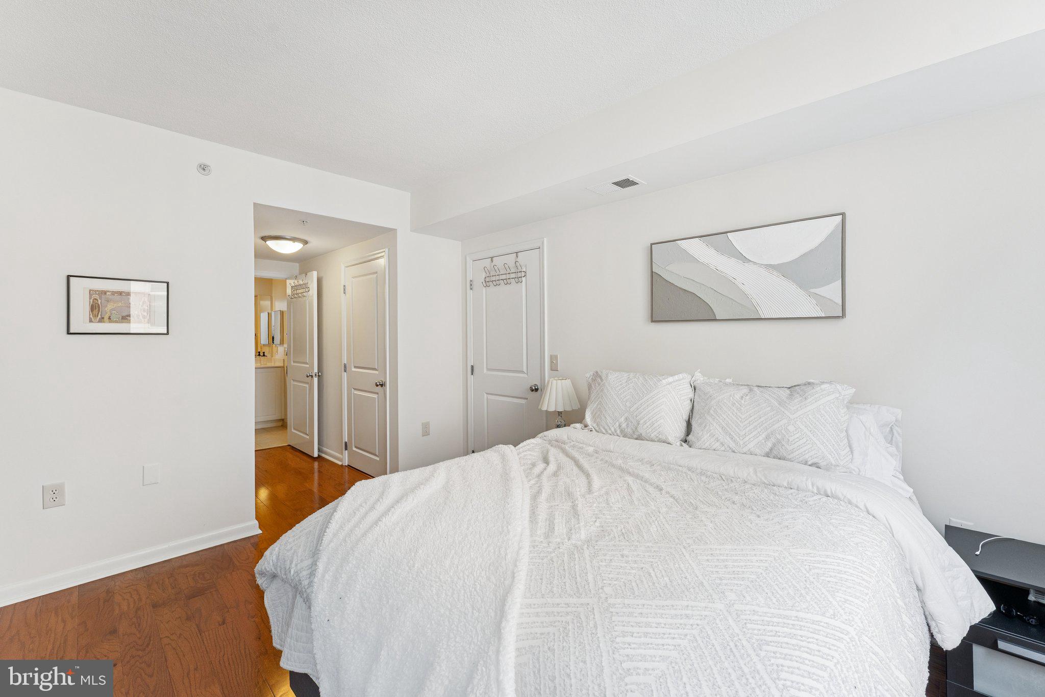 851 North Glebe Road, Unit 718 Arlington, VA 22203 - Photo 16 of 37 a bedroom with a bed and a painting on the wall