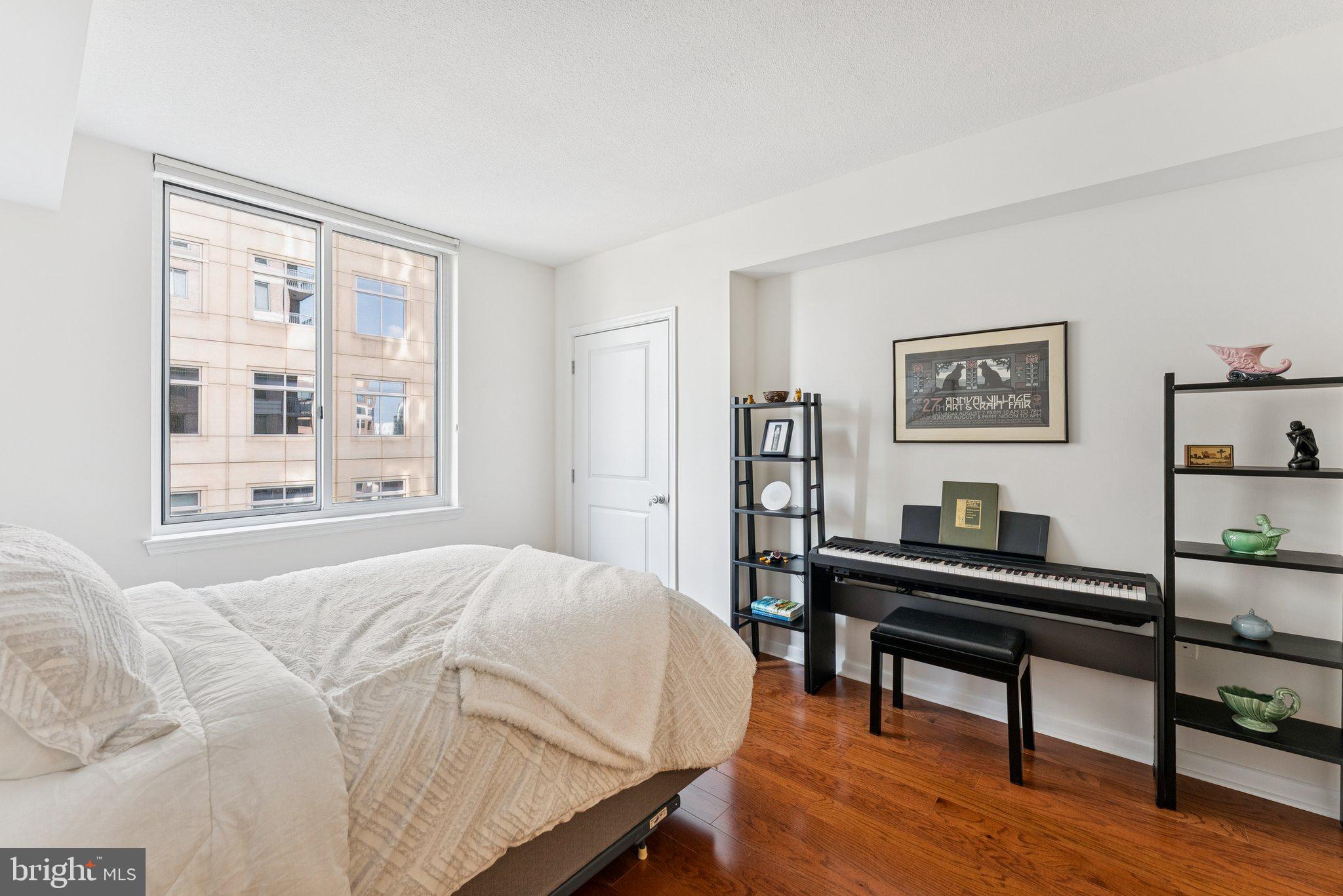 851 North Glebe Road, Unit 718 Arlington, VA 22203 - Photo 18 of 37 a bedroom with a bed table two chairs and a window