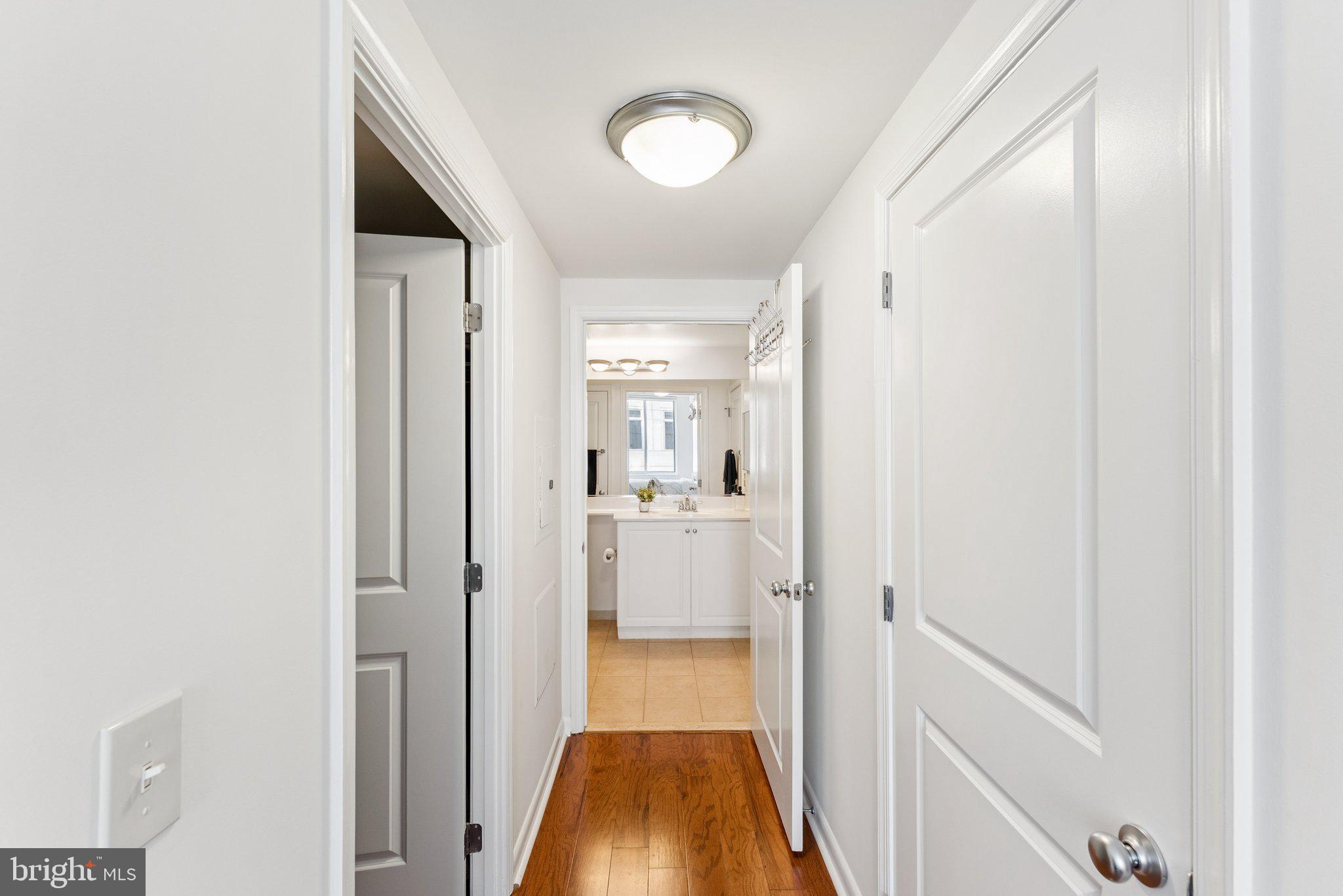 851 North Glebe Road, Unit 718 Arlington, VA 22203 - Photo 19 of 37 a view of a hallway with wooden floor and a bathroom