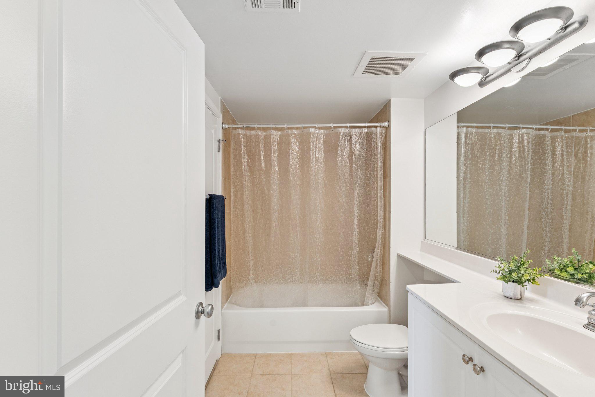 851 North Glebe Road, Unit 718 Arlington, VA 22203 - Photo 20 of 37 a bathroom with a bathtub a sink a toilet a window