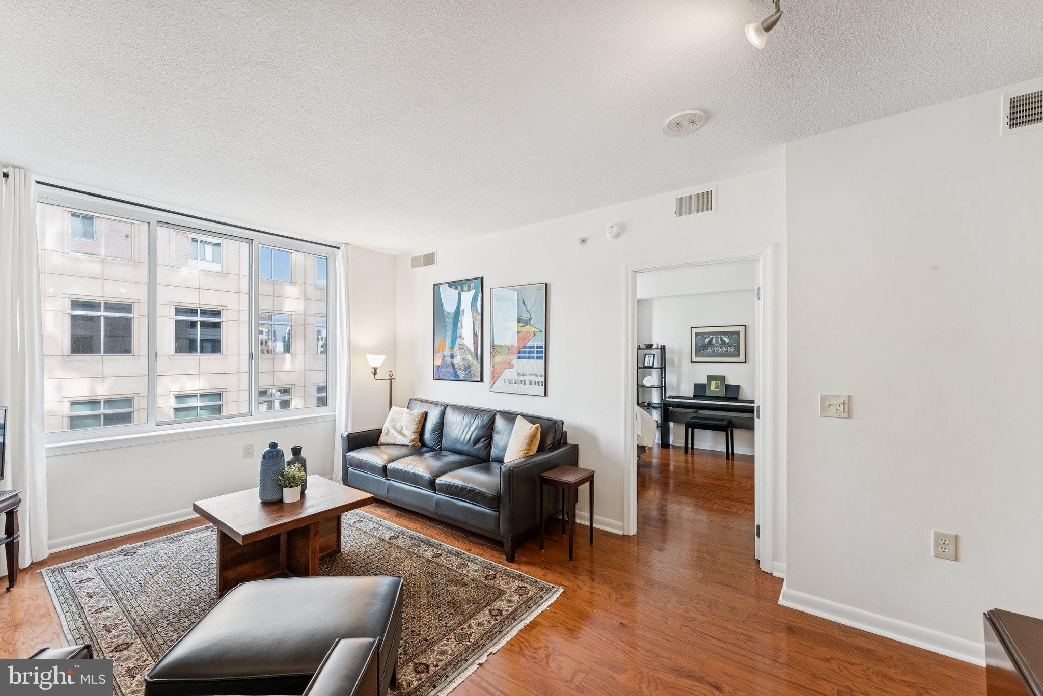 851 North Glebe Road, Unit 718 Arlington, VA 22203 - Photo 2 of 37 a living room with furniture wooden floor and a large window