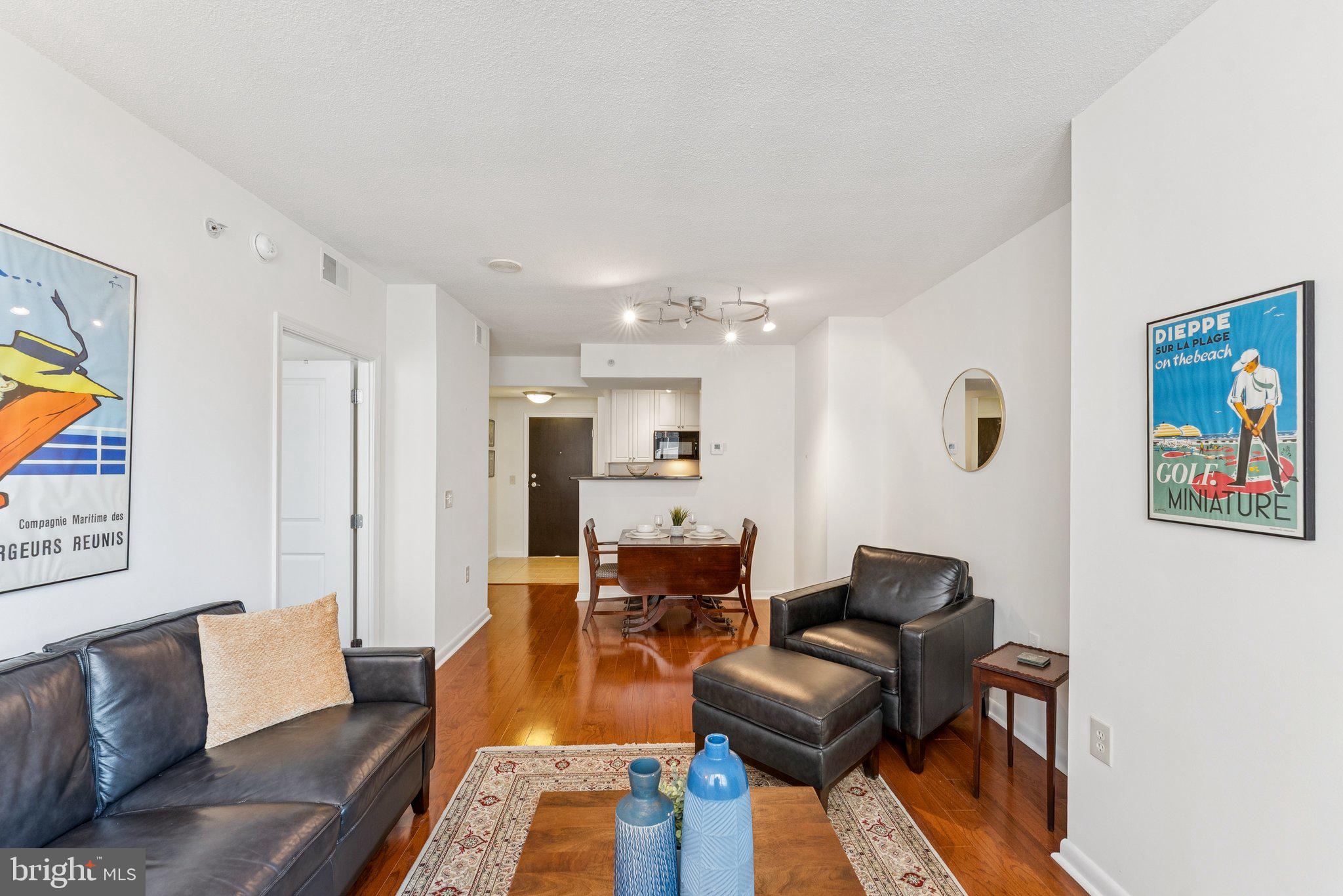 851 North Glebe Road, Unit 718 Arlington, VA 22203 - Photo 6 of 37 a living room with furniture and a flat screen tv