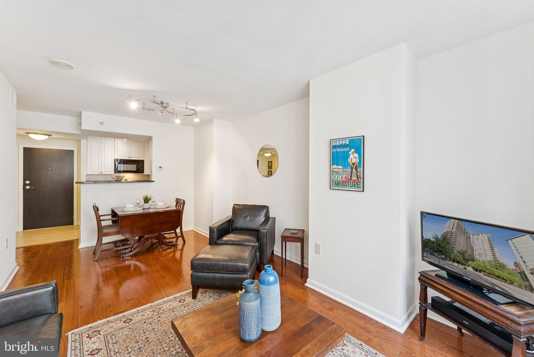851 North Glebe Road, Unit 718 Arlington, VA 22203 - Photo 7 of 37 a living room with furniture and a flat screen tv