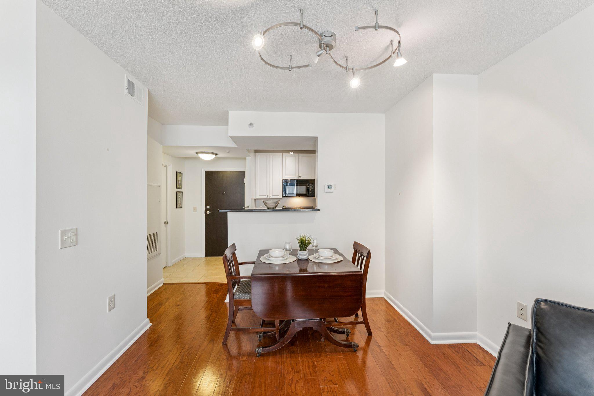 851 North Glebe Road, Unit 718 Arlington, VA 22203 - Photo 9 of 37 a view of a dining room with furniture and wooden floor