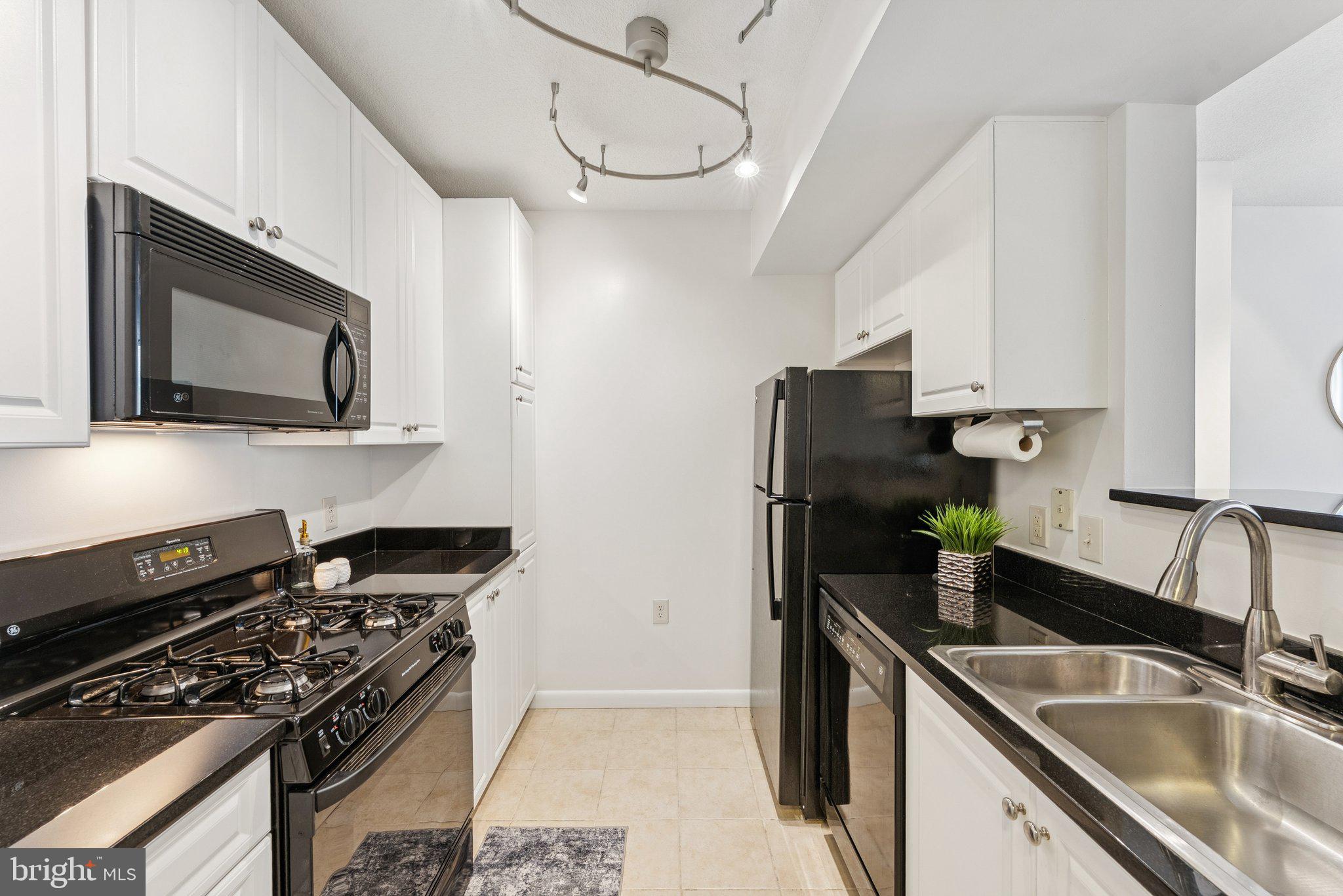 851 North Glebe Road, Unit 718 Arlington, VA 22203 - Photo 10 of 37 a kitchen with a sink stove top oven and microwave