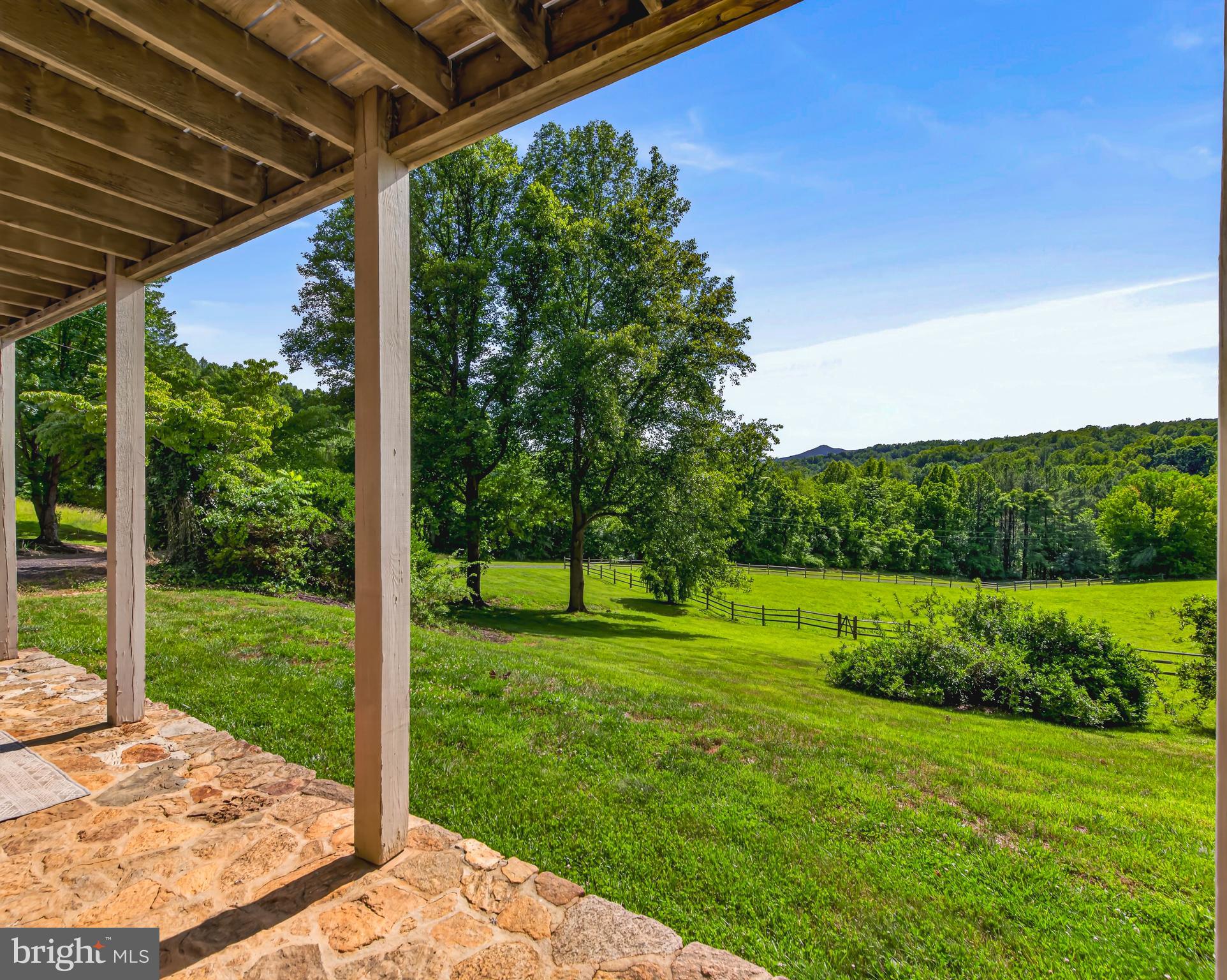 4028 South F T Valley Road Etlan, VA 22719 - Photo 79 of 101 a view of a backyard with table and chairs under an umbrella