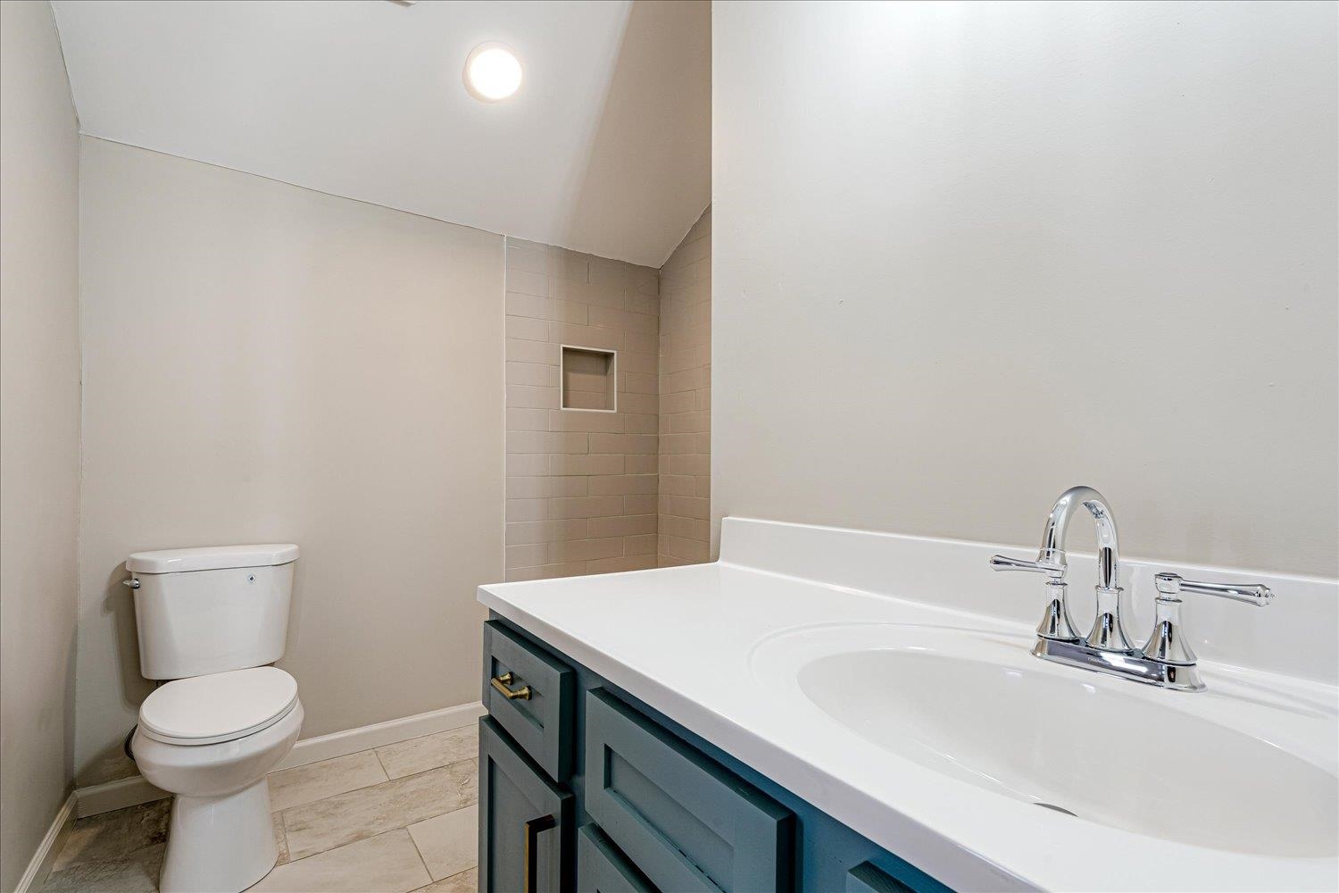 1069 Blythe Street Memphis, TN 38104 - Photo 12 of 24 Bathroom featuring lofted ceiling, vanity, and light tile patterned floors