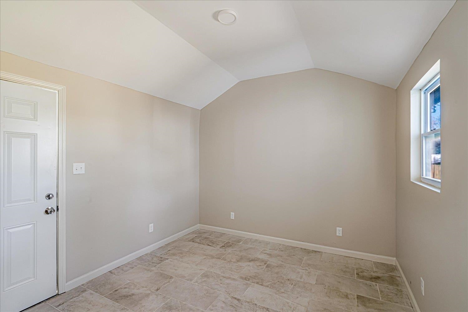 1069 Blythe Street Memphis, TN 38104 - Photo 19 of 24 Additional living space featuring vaulted ceiling and baseboards