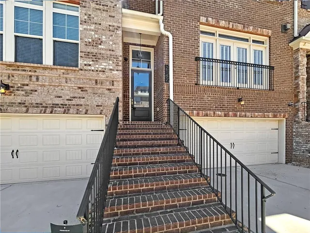 a view of a brick house with many windows