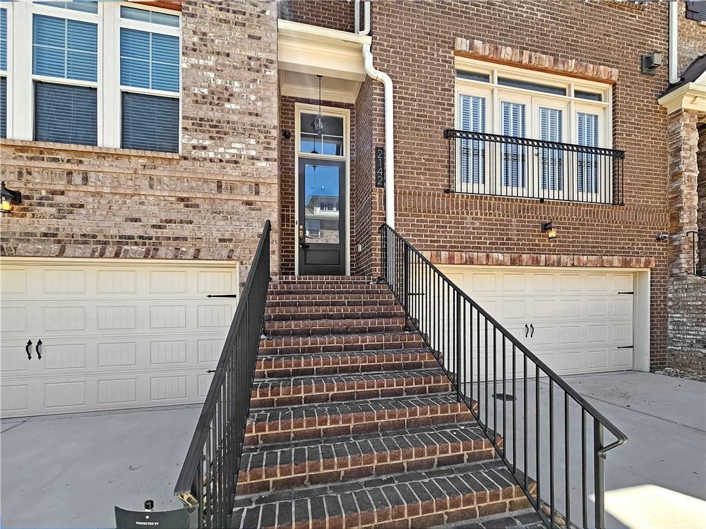 a view of a brick house with many windows