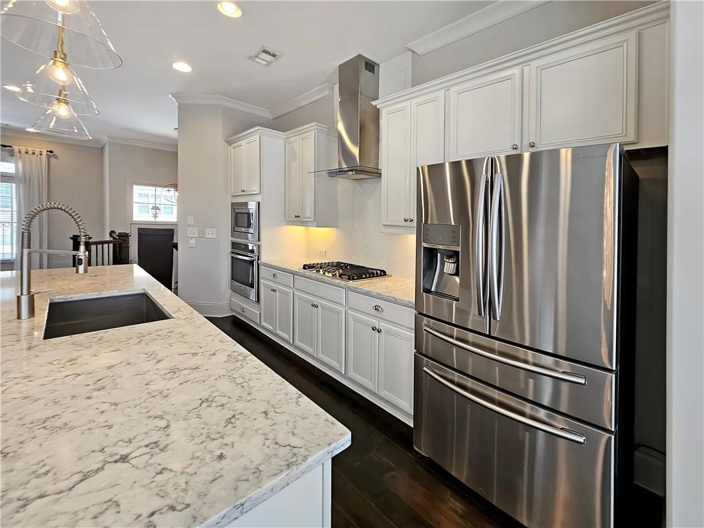 2142 Coventry Drive Brookhaven, GA 30319 - Photo 13 of 52 a kitchen with kitchen island a counter top space cabinets and stainless steel appliances