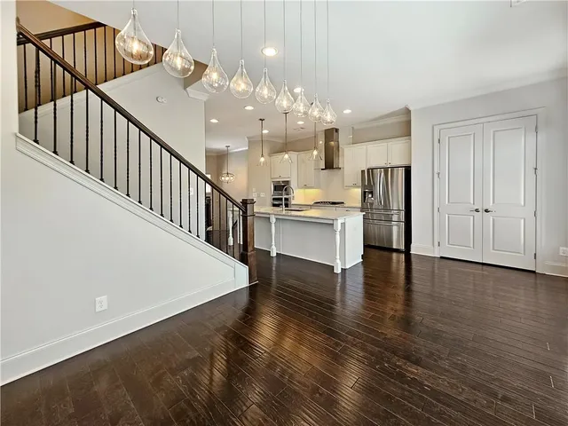 a open kitchen with white cabinets and stainless steel appliances