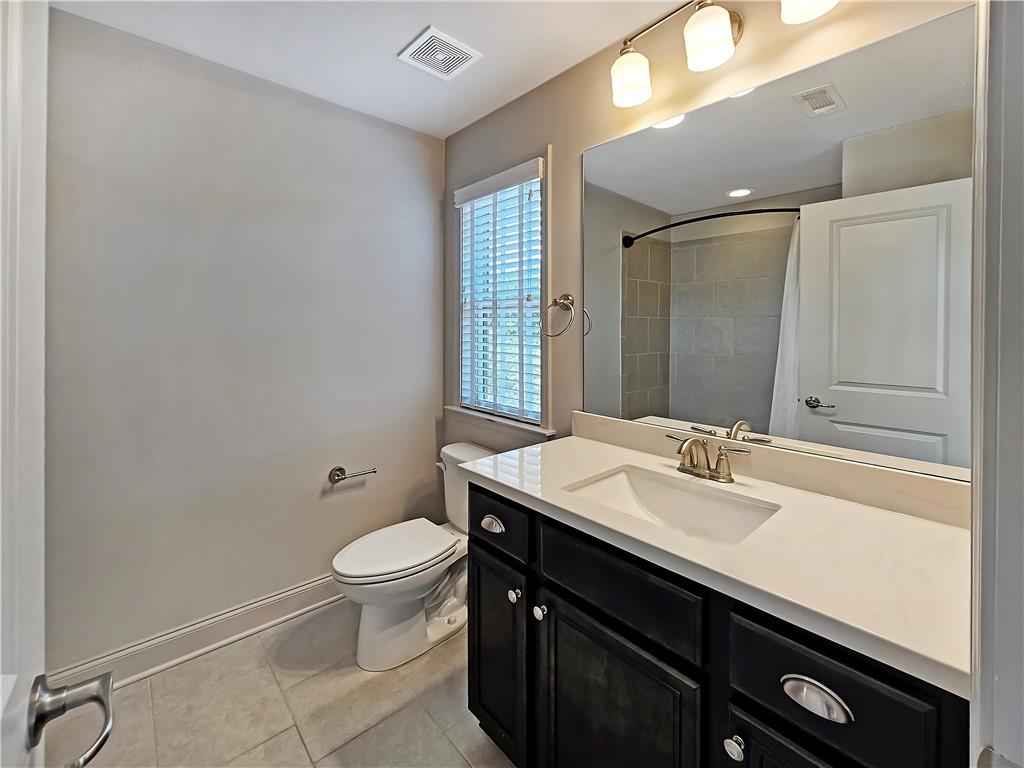 2142 Coventry Drive Brookhaven, GA 30319 - Photo 29 of 52 a bathroom with a sink a toilet a mirror and shower