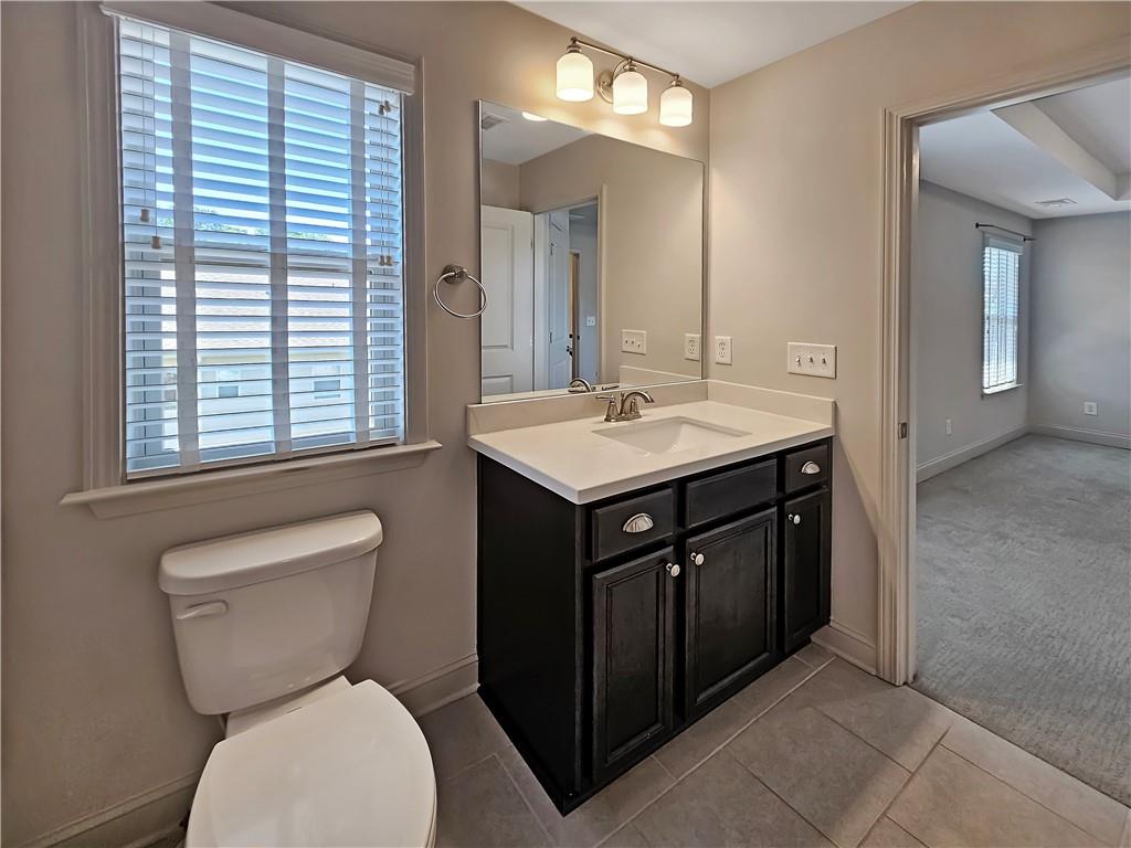 2142 Coventry Drive Brookhaven, GA 30319 - Photo 31 of 52 a bathroom with a toilet sink and mirror